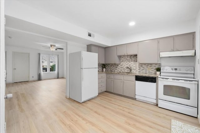 kitchen featuring tasteful backsplash, light wood-type flooring, gray cabinetry, and white appliances