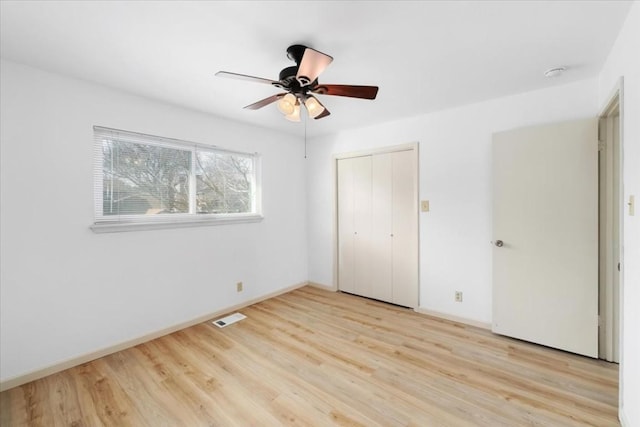 unfurnished bedroom with a closet, ceiling fan, and light wood-type flooring