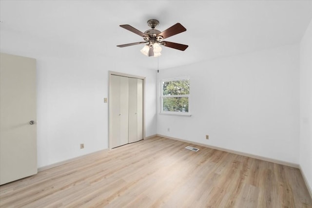 unfurnished bedroom with a closet, ceiling fan, and light hardwood / wood-style flooring