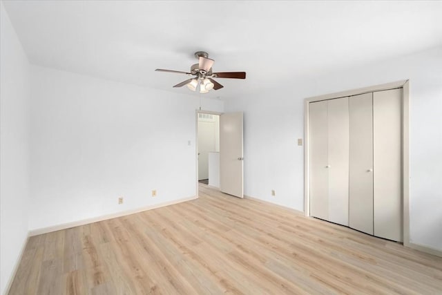 unfurnished bedroom with a closet, ceiling fan, and light hardwood / wood-style flooring