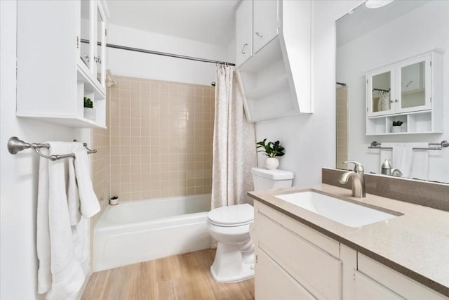 full bathroom with vanity, toilet, shower / tub combo, and wood-type flooring