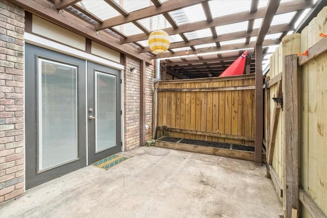 view of patio with french doors and a pergola