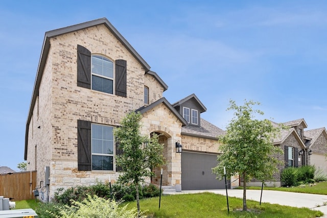 french country inspired facade with a garage and a front yard