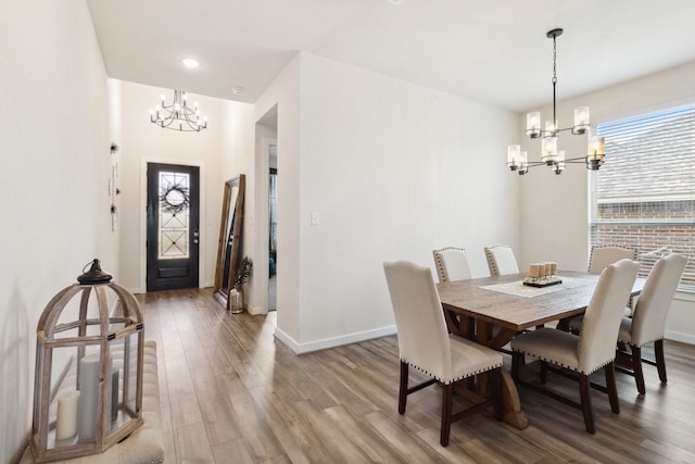 dining space featuring a notable chandelier and wood-type flooring