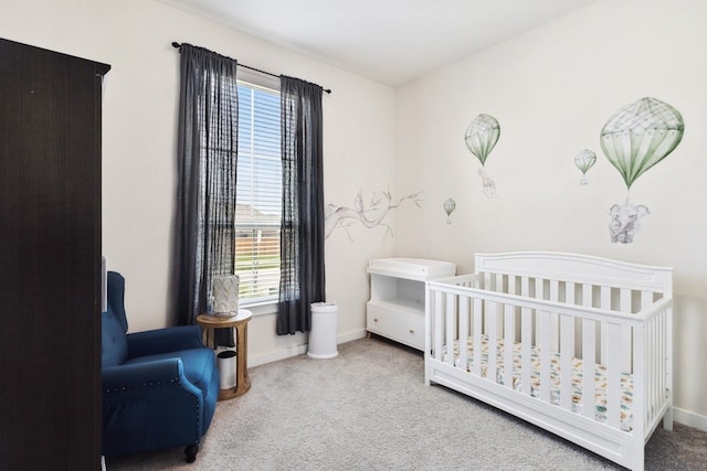 bedroom with a crib and light colored carpet