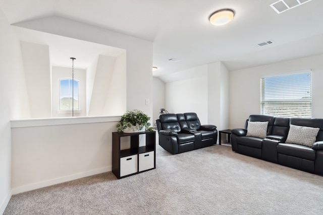 carpeted living room featuring vaulted ceiling