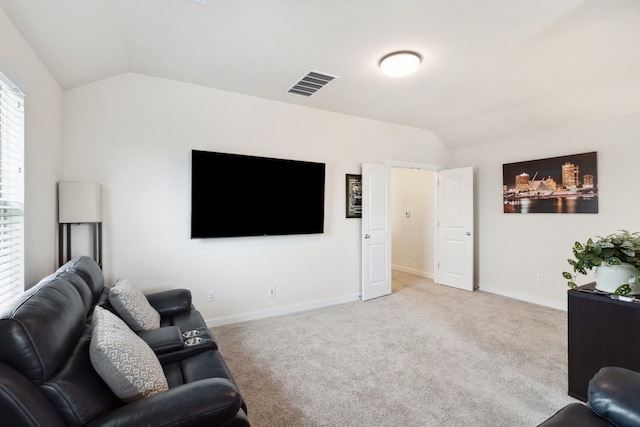 living room featuring lofted ceiling and light carpet