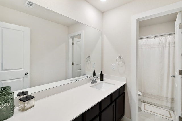 bathroom with a shower with shower curtain, vanity, toilet, and tile patterned flooring