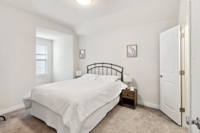 carpeted bedroom with lofted ceiling