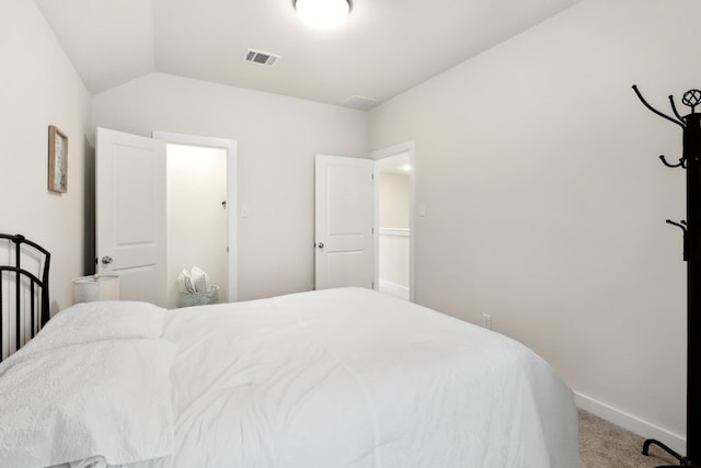 carpeted bedroom featuring vaulted ceiling