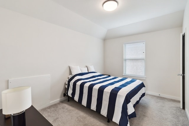 carpeted bedroom featuring lofted ceiling