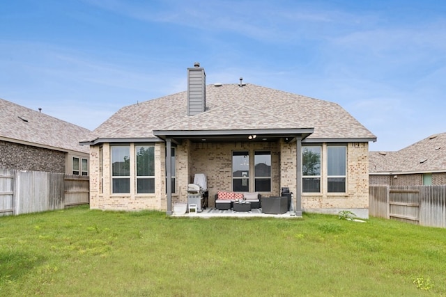 back of house featuring a yard, an outdoor hangout area, and a patio area