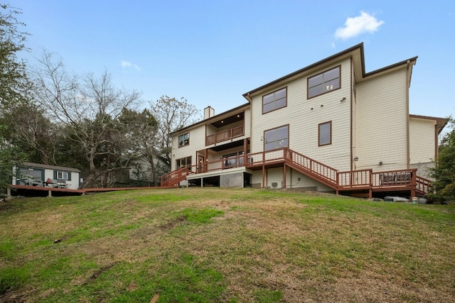 back of property with a yard and a deck