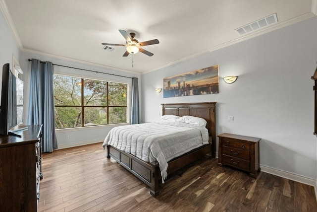 bedroom with crown molding, ceiling fan, and dark hardwood / wood-style floors