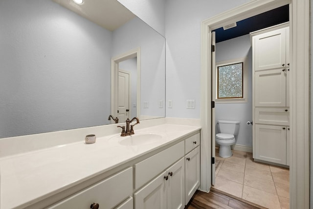 bathroom with vanity, tile patterned floors, and toilet