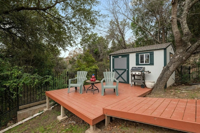 deck with a grill and a storage unit