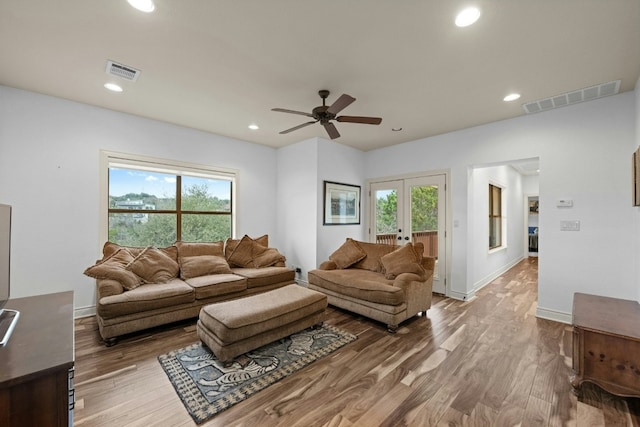 living room with hardwood / wood-style flooring, a wealth of natural light, and french doors