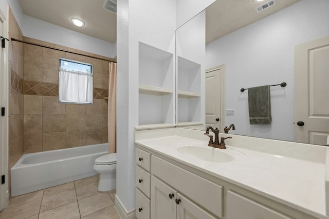 full bathroom featuring vanity, tiled shower / bath, tile patterned floors, and toilet