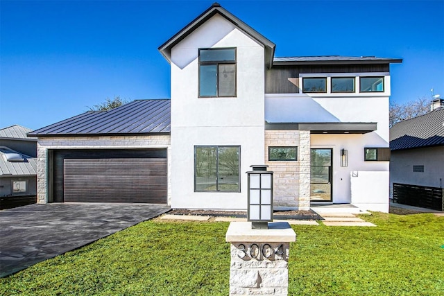 view of front of property with a garage and a front lawn