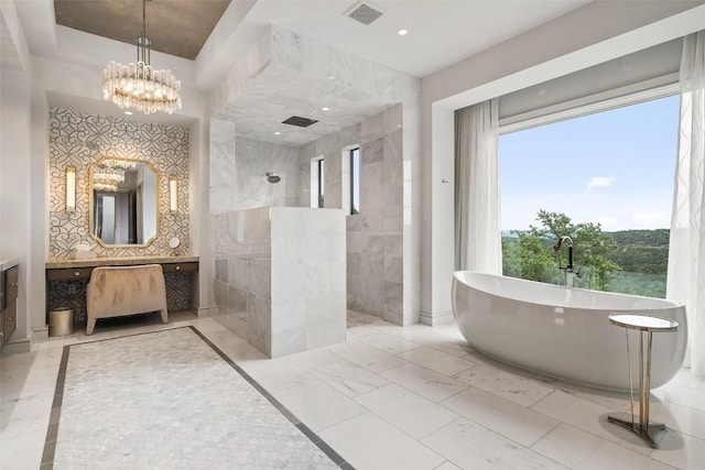 bathroom featuring vanity, a notable chandelier, and plus walk in shower