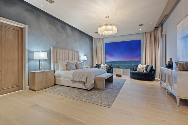 4901 Mirador Dr, Austin, TX 78735 - bedroom with light wood-style flooring, a chandelier, an accent wall, and recessed lighting
