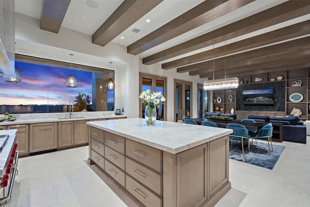 kitchen with sink, hanging light fixtures, a center island, stainless steel range, and beamed ceiling