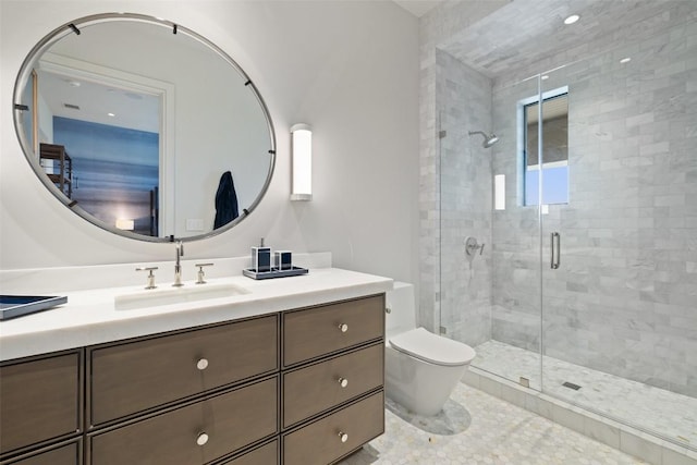 bathroom featuring vanity, toilet, and a stall shower