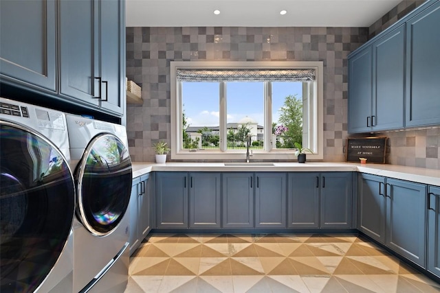 laundry area with a sink, cabinet space, recessed lighting, and washing machine and clothes dryer