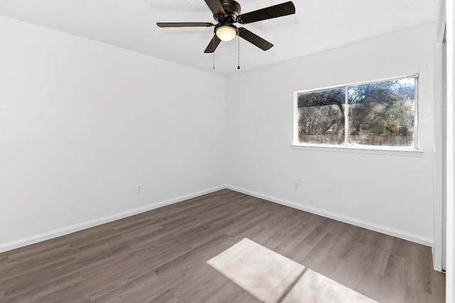 unfurnished room featuring dark hardwood / wood-style floors and ceiling fan