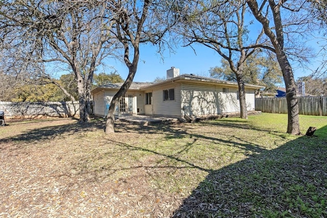 rear view of property with a lawn