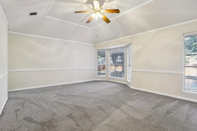 empty room featuring crown molding, vaulted ceiling, ceiling fan, and carpet