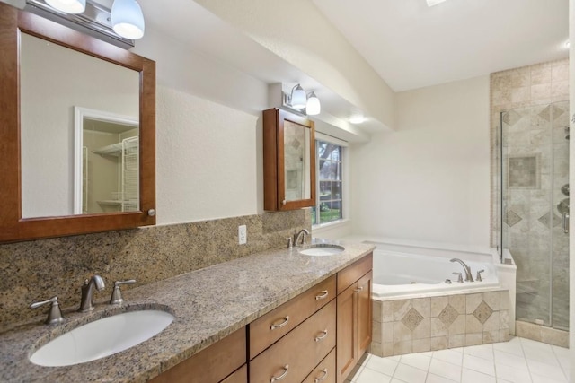 bathroom featuring tasteful backsplash, vanity, tile patterned flooring, and shower with separate bathtub