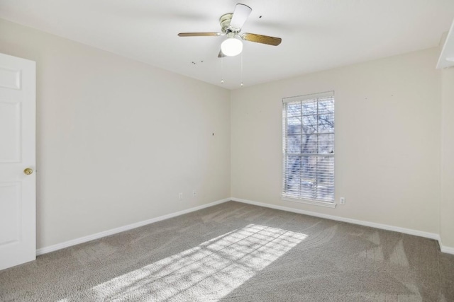 carpeted spare room with ceiling fan