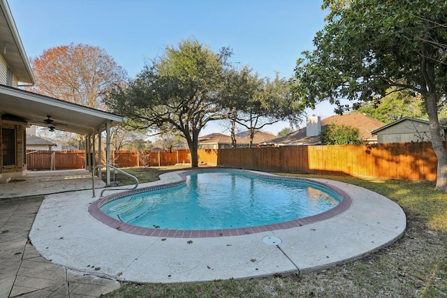 view of swimming pool with ceiling fan and a patio area