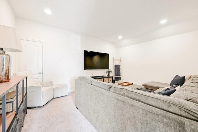 living room with lofted ceiling and light carpet