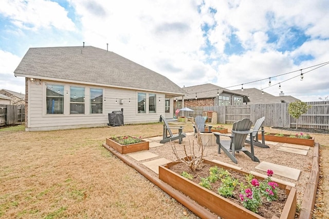 rear view of property featuring a yard