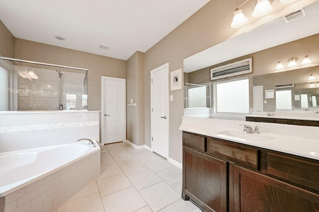 bathroom featuring tile patterned flooring, plus walk in shower, and vanity