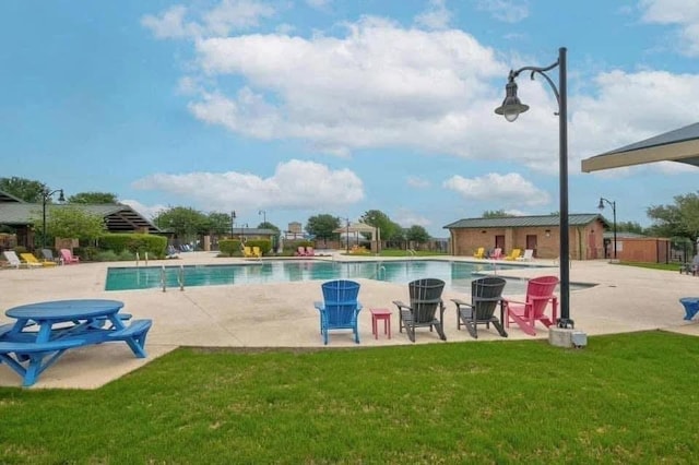 view of pool featuring a yard and a patio area