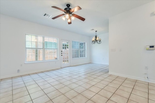 unfurnished room featuring ceiling fan with notable chandelier