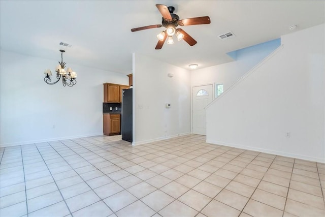 unfurnished living room featuring ceiling fan with notable chandelier