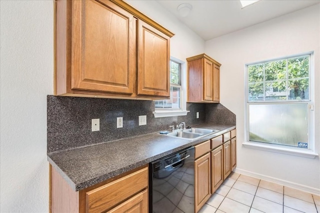 kitchen featuring tasteful backsplash, dishwasher, sink, and light tile patterned flooring