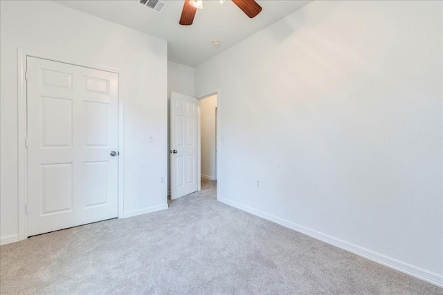 unfurnished bedroom featuring light colored carpet and ceiling fan