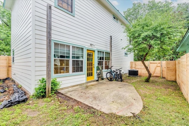 rear view of property featuring cooling unit and a patio area