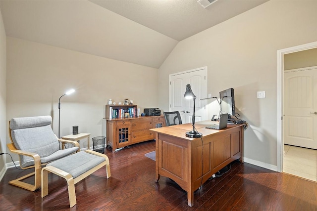 office space with dark hardwood / wood-style floors and vaulted ceiling