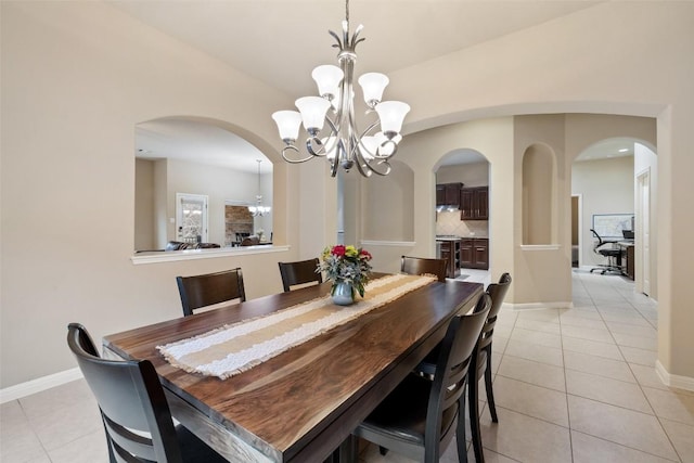 tiled dining area featuring a notable chandelier