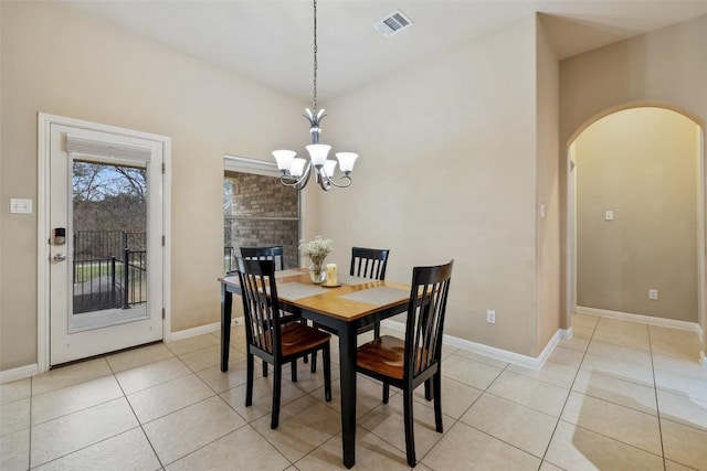 tiled dining area featuring a notable chandelier