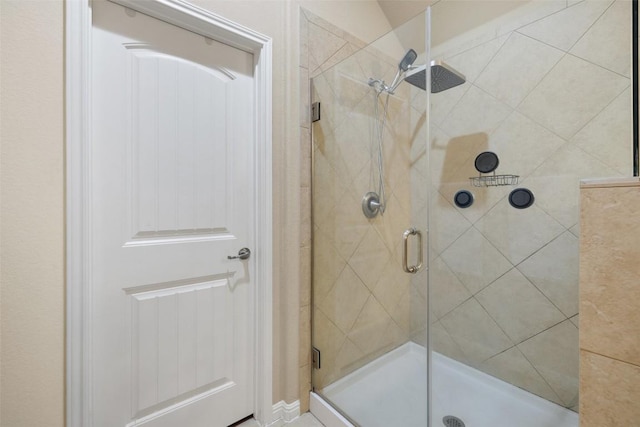 bathroom featuring a shower with door