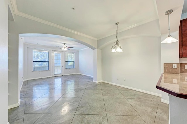 empty room featuring ceiling fan, ornamental molding, and light tile patterned floors