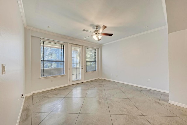 tiled empty room featuring ornamental molding and ceiling fan