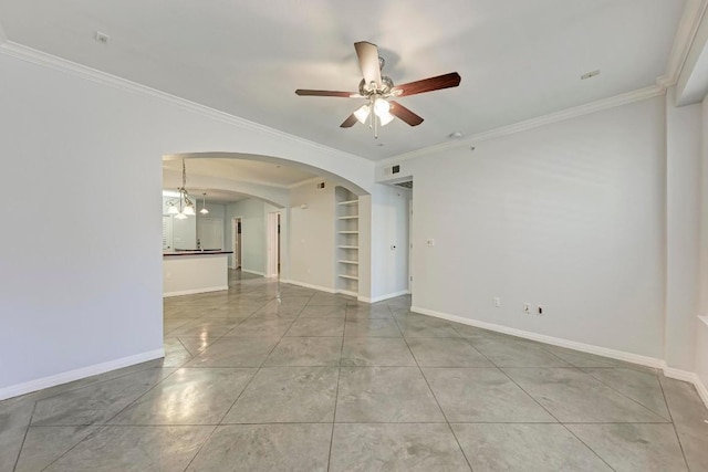 tiled empty room with crown molding, built in features, and ceiling fan